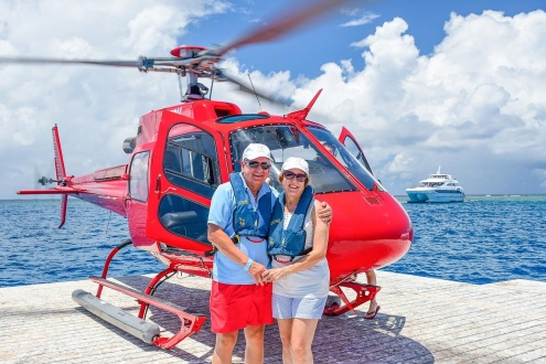 Couple taking a scenic helicopter flight from a Great Barrier Reef pontoon.